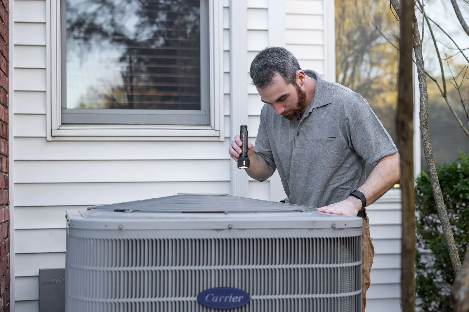 Technician servicing heating system components